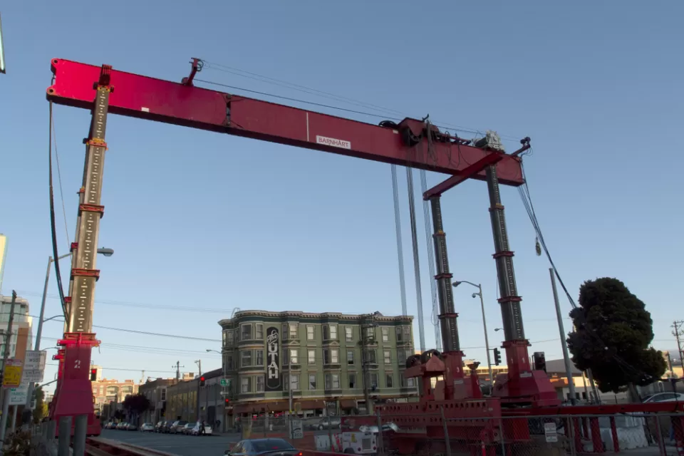 Construction crane and equipment on 4th Street for Central Subway project in San Francisco, California